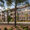 a building with trees and grass