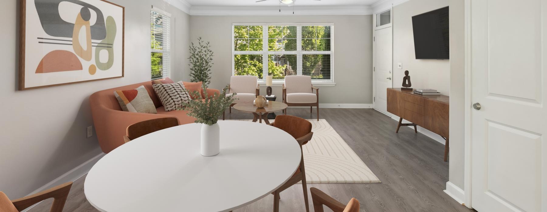 a living room with a table and chairs