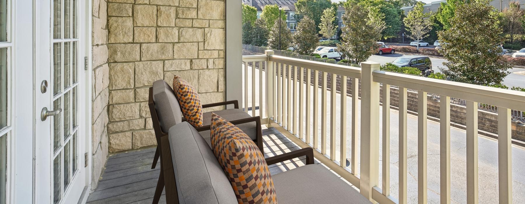 a balcony with chairs and a railing